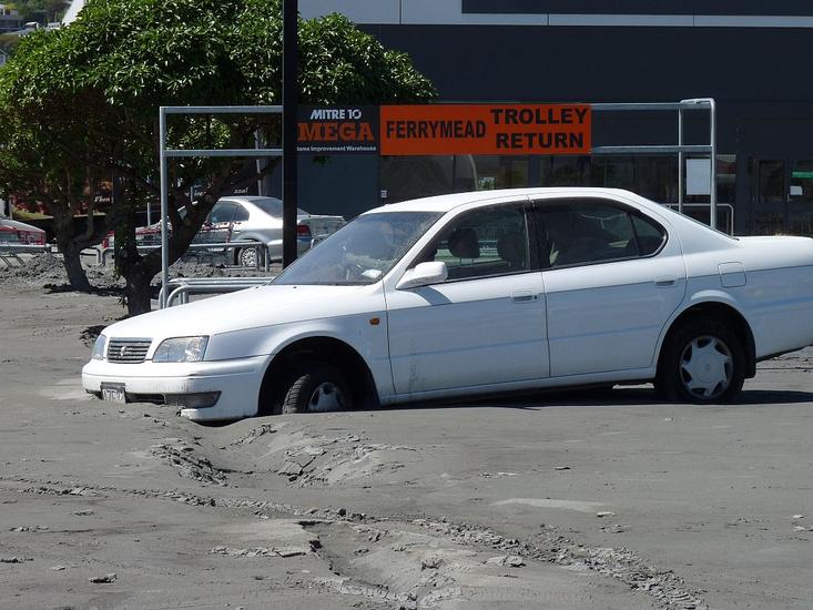 Car trapped by liquefaction in Ferrymead, Christchurch. [GNS Science]