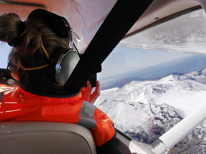 Volcanologist sitting in plane doing the Ngauruhoe monthly gas flux flight