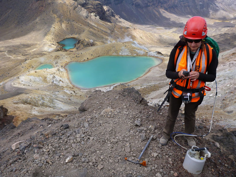 Female scientist reading data of Soil Gas Flux Measurements Red Crater.